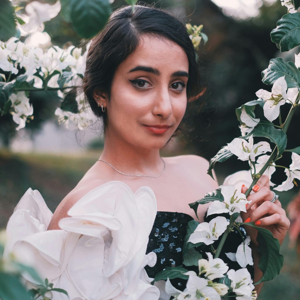Portrait of a woman with white flowers, exuding elegance and grace.